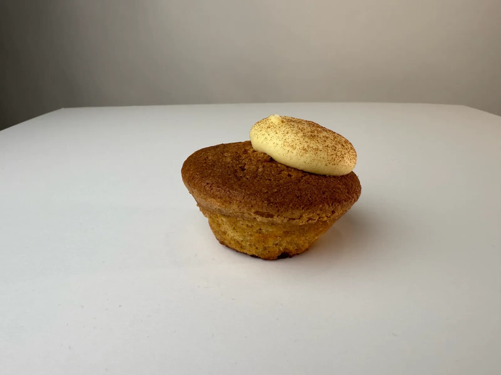 The same bun again a little further back, shadowless on a white worktop against a grey wall